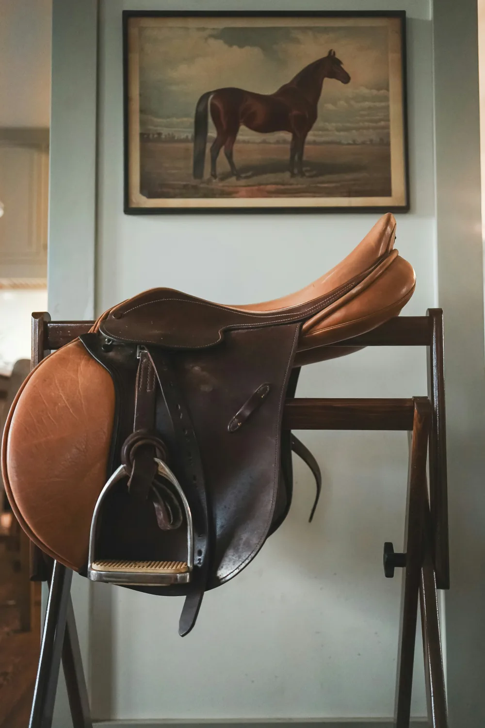 A saddle resting on a rack, unused